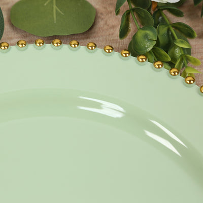 Mint green plate with gold beaded rim and greenery accents.