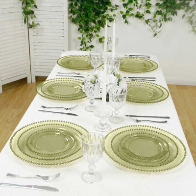 Elegant green dinnerware set arranged on a beautifully styled dining table.