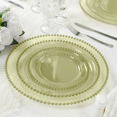Elegant green glass charger plates stacked on a dining table setting.