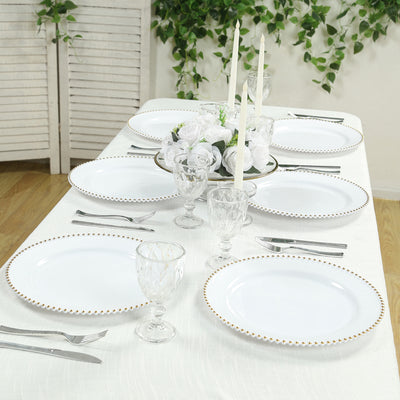 Elegant dining table setting with white plates and glassware.