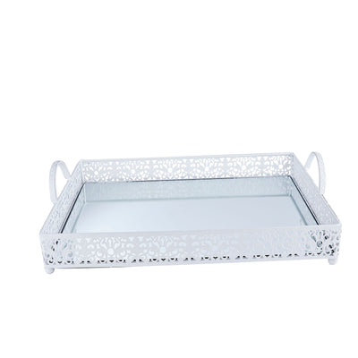 White decorative tray with intricate cutout design and mirrored base