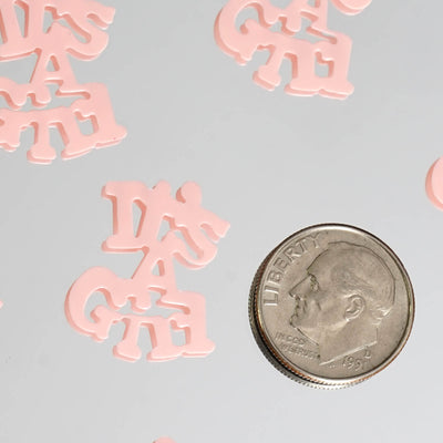 Pink plastic letters "DAGATE" with a quarter for scale