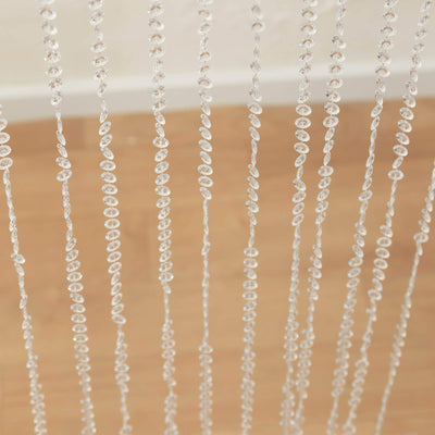 Clear beaded curtain strands hanging in a room