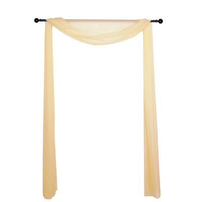 Yellow sheer drapery fabric on a black curtain rod