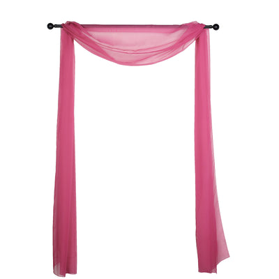 Pink sheer fabric draped on a black curtain rod
