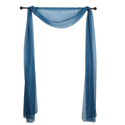 Blue sheer curtain draped elegantly on a rod