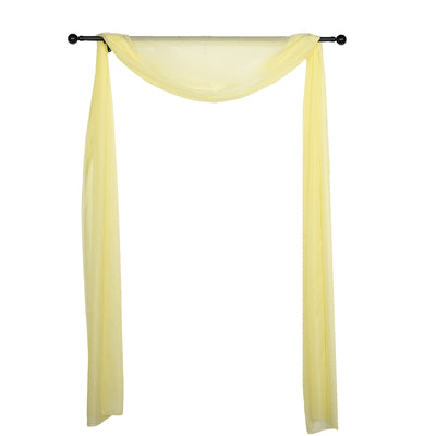 Yellow sheer fabric draped on a black rod for decorative use