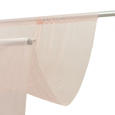 Sheer beige curtain on silver rod with decorative valance clip