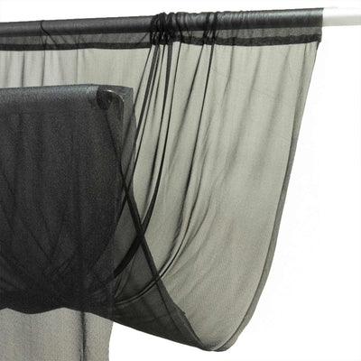 Black sheer mesh curtain draped on a rod with soft folds