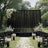 Elegant outdoor wedding ceremony setup with black drape backdrop and white florals