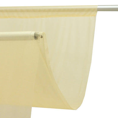 Sheer cream window curtain on a rod with soft translucent fabric