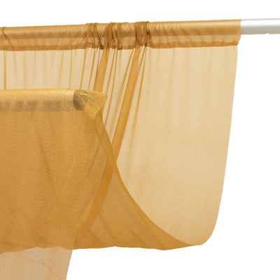 Sheer gold curtain panel on a rod, elegant window treatment