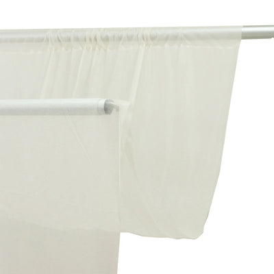 Sheer white curtain panel on a silver curtain rod, minimalist interior decor