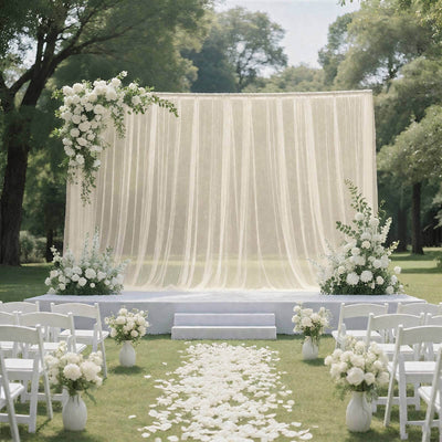 Elegant outdoor wedding ceremony with white floral arch and aisle petals