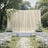 Elegant outdoor wedding ceremony with white floral arch and aisle petals