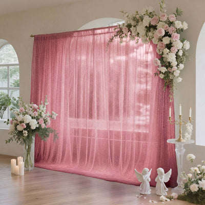 Pink floral wedding backdrop with sheer curtain, candles, and elegant decor