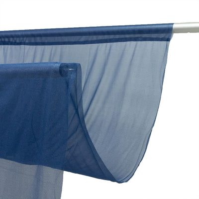 Blue sheer fabric draped over a white curtain rod on a white background