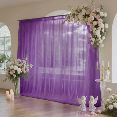 Purple wedding backdrop with white and pink floral arrangements and candles