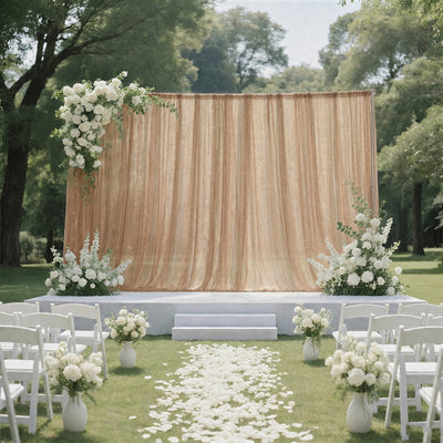 Elegant outdoor wedding ceremony setup with white flowers and gold backdrop