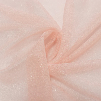 Soft blush pink sheer tulle fabric close-up with delicate folds#whtbkgd