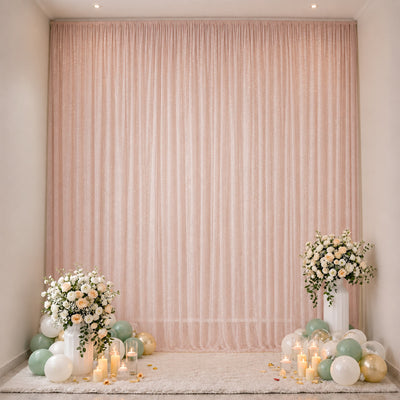 Pastel wedding backdrop with flowers, balloons, and candles
