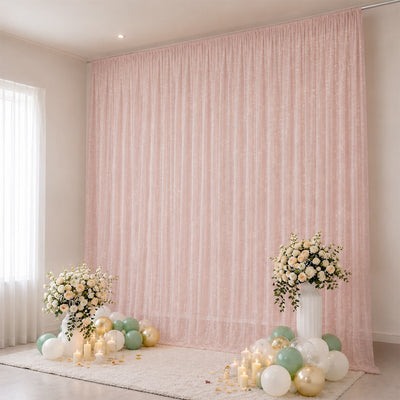 Elegant pastel pink wedding backdrop with flowers, candles, and balloons