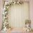 Pastel balloon and floral event backdrop with candles and white drapes