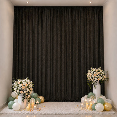 Elegant floral balloon birthday backdrop with candles and black drapes
