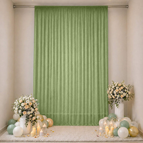 Green sheer curtain wedding backdrop with floral arrangements and balloons