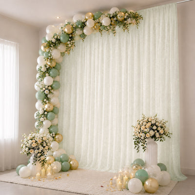 Mint and gold balloon arch with floral wedding backdrop and candles