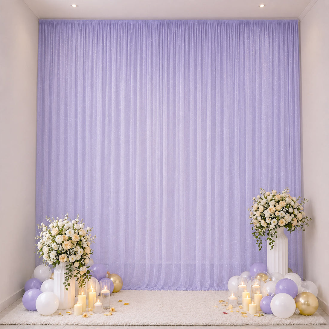 Lavender party backdrop with floral stands, balloons, and candles for celebration