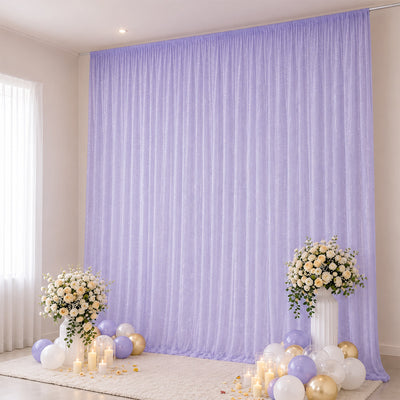 Lavender wedding backdrop with floral arrangements, balloons, and candles