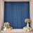 Elegant blue curtain backdrop with floral arrangements, candles, and balloons