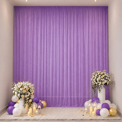 Elegant purple party backdrop with floral arrangements and balloons