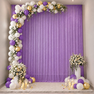 Purple, white and gold balloon arch with floral backdrop for elegant party decor