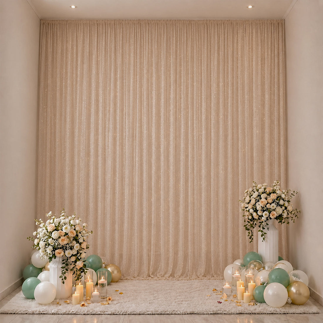 Elegant floral and balloon party backdrop with candles and soft beige drapes
