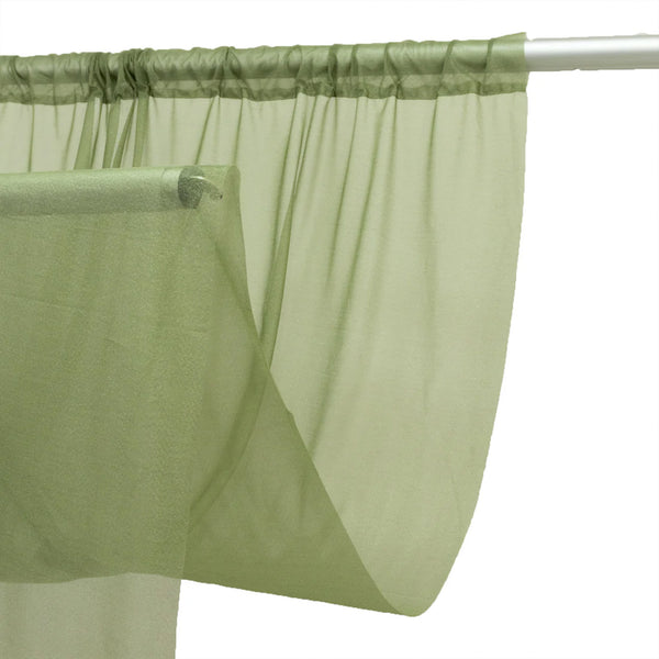 Light green sheer curtain panel on a white curtain rod