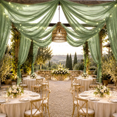 Elegant outdoor wedding reception with draped greenery and scenic hillside views