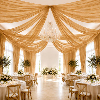 Elegant wedding reception hall with gold draped ceiling and chandelier