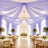 Lavender draped wedding reception with chandelier and floral tableside decor