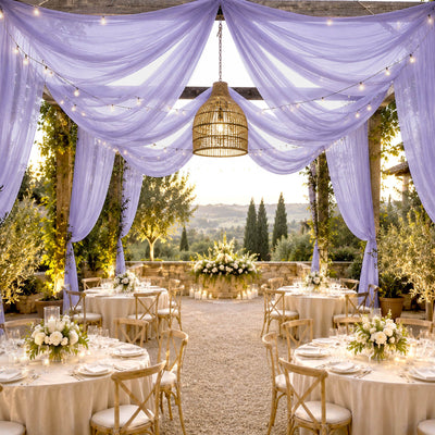 Elegant outdoor wedding reception with lavender drapes and fairy lights