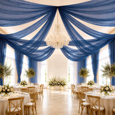 Elegant wedding reception with blue draped ceiling and chandelier