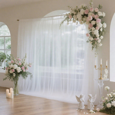 Elegant floral backdrop with draped white fabric and decorative accents.