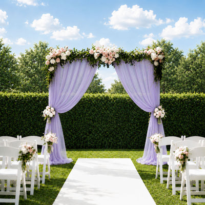 Outdoor wedding ceremony arch with lavender drapes and floral decorations