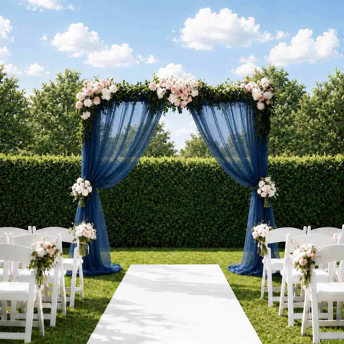 Elegant outdoor wedding arch with blue drapes, flowers, and white chairs