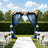Elegant outdoor wedding arch with blue drapes, flowers, and white chairs