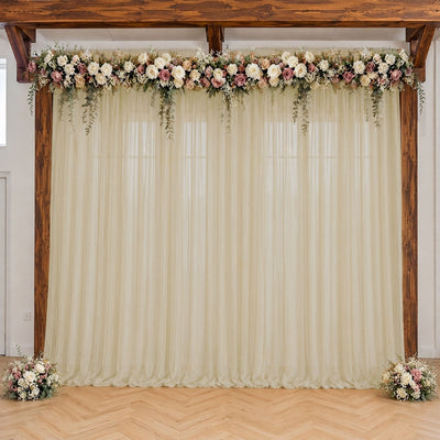 Wedding floral backdrop with cream drapes, roses, and rustic wooden frame