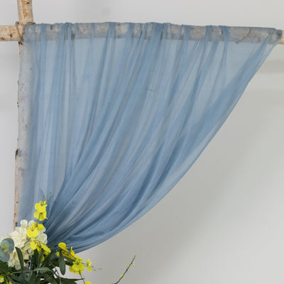 Sheer blue fabric draped elegantly with flowers below