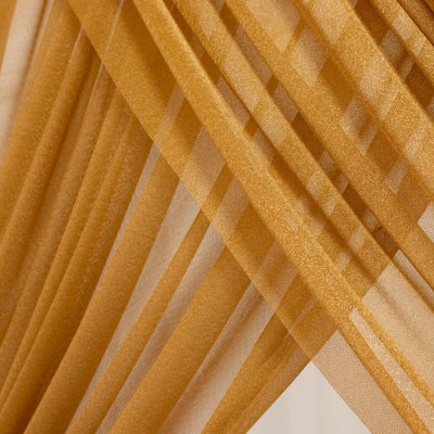 Gold sheer fabric drapes with abstract diagonal folds and texture #whtbkgd