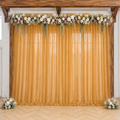 Gold wedding backdrop with floral garland and sheer curtain, rustic wooden frame